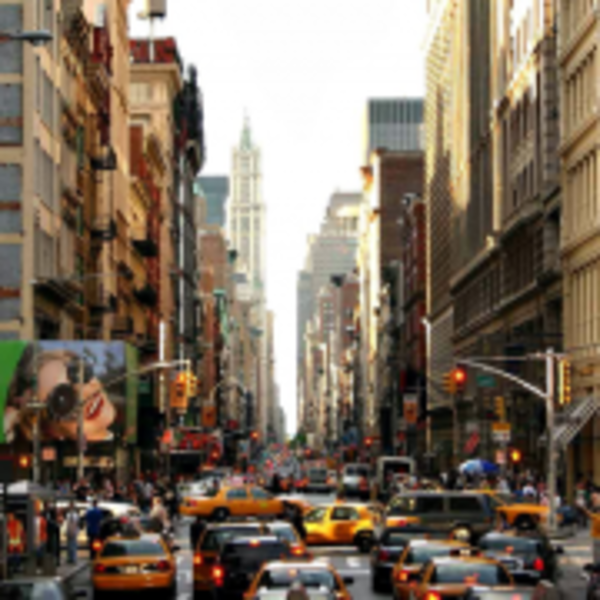A New York street with tall buildings on each side and lots of traffic