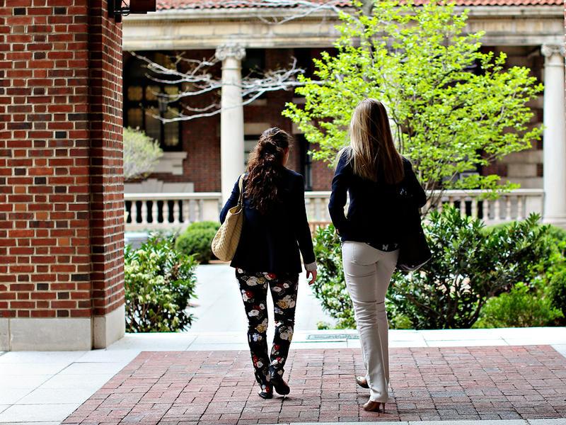 2 students walking on campus